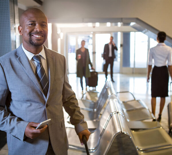 Man-smiling-holding-a-travel-bag